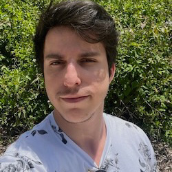 Selfie of Daniel Molares in front of foliage